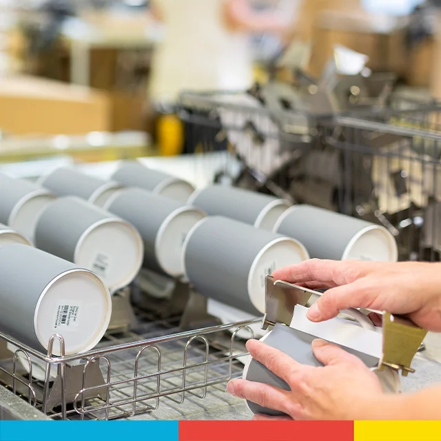 Fototassen in der Produktion – Rohlinge werden vorbereitet für den Druck personalisierter bunter Tassen mit Bildmotiv.