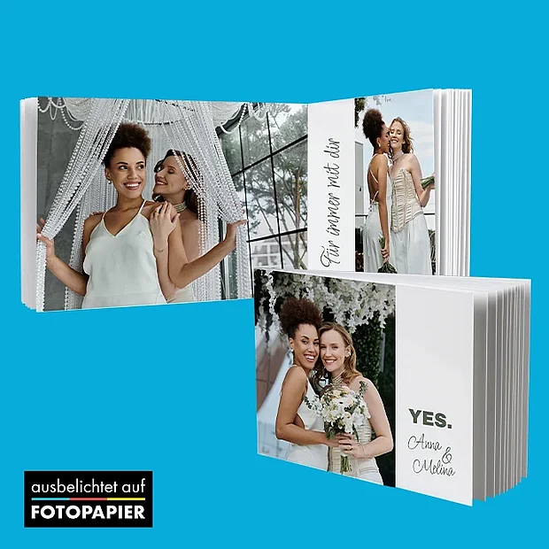 Hochzeitsfotobuch auf Fotopapier mit Brautpaar und emotionalen Momenten in modernem Layout