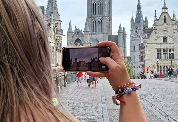 Junge Frau fotografiert mit Ihrem Smartphone in der Stadt. Handy-Fotografie Tricks findest du bei ORWO.