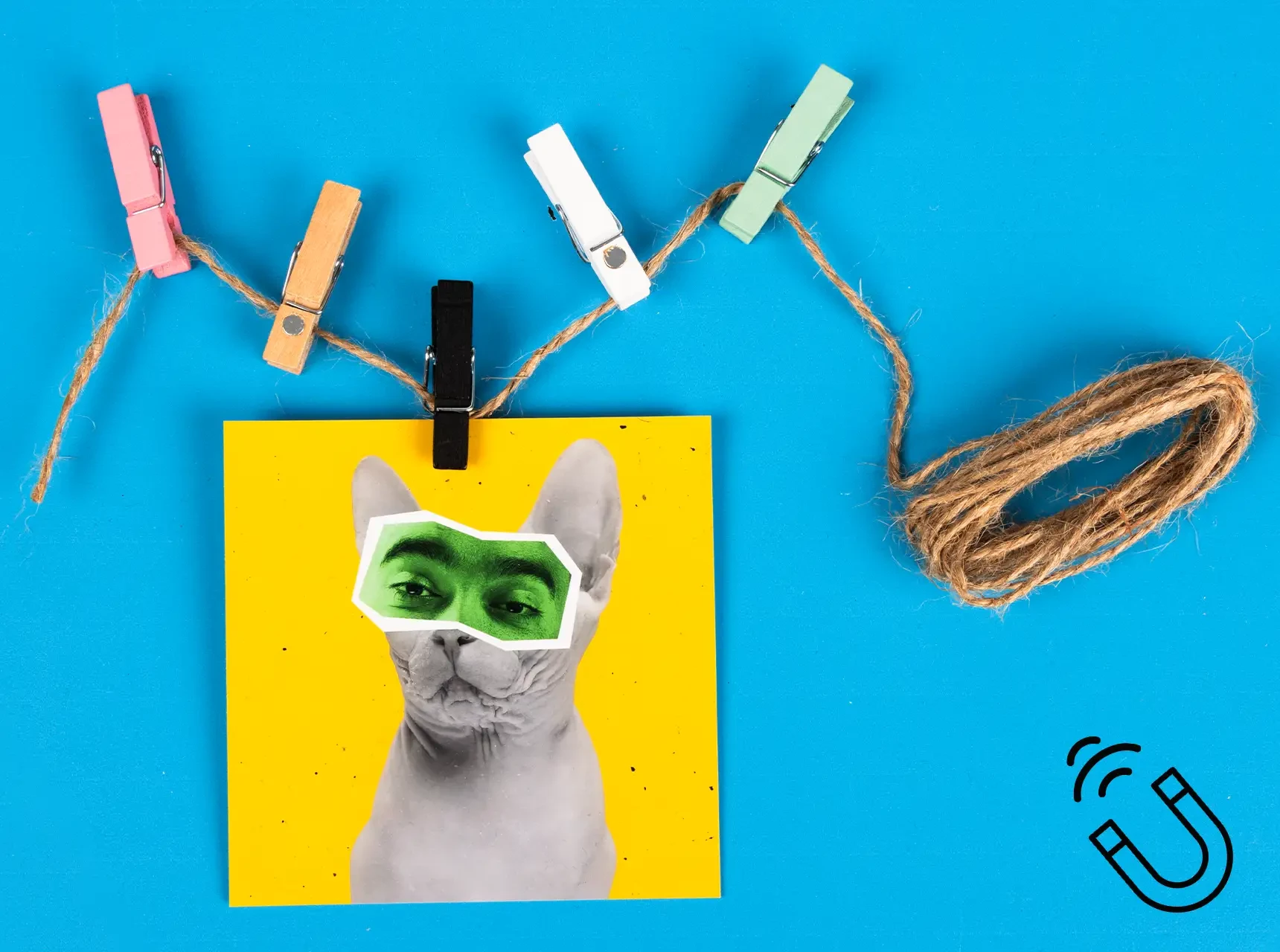 Fünf farbige Magnet Clips mit Mini-Magneten halten ein Comicstil-Katzenfoto an einer Deko-Schnur.