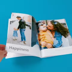 Fotobuch erstellen mit großen Fotos auf der Innenseite Fotobuch als Fotoheft gestalten. Innenseiten mit großen Familien-Fotos von besonderen Momenten und passendem Schriftzug personalisiert, im Hochformat.