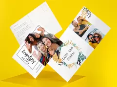 Foto-Postkarten im Hochformat mit mehreren persönlichen Fotos von Freunden und Paaren, moderne Gestaltung mit floralen Illustrationen, Schriftzügen wie „Happy Birthday“ und „Lasst uns feiern“, Vorder- und Rückseite sichtbar vor gelbem Hintergrund.